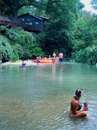 a group of people swimming in a river at Rest and Relax in Texas in this Great Safari Tent Getaway in Cibolo in Marion