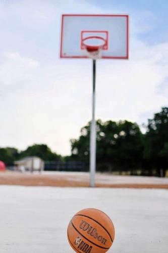 a basketball ball sitting next to a basketball hoop at Rest and Relax in Texas in this Great Safari Tent Getaway in Cibolo in Marion