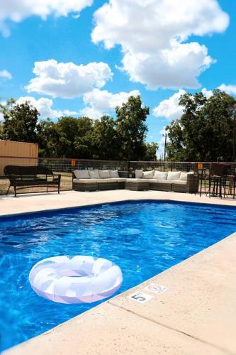 a swimming pool with a white object in the water at Rest and Relax in Texas in this Great Safari Tent Getaway in Cibolo in Marion