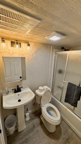a small bathroom with a toilet and a sink at Rest and Relax in Texas in this Great Safari Tent Getaway in Cibolo in Marion