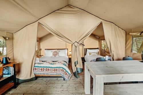a bedroom with two beds in a tent at Charming Safari Tent with Sauna and Fire Pit in North Woodstock, New Hampshire in Woodstock