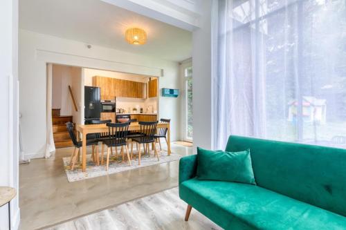 a living room with a couch and a table and chairs at Barthélémy cozy house in the city center in Rouen
