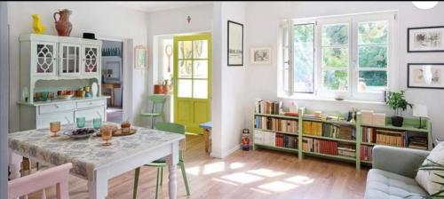 a living room with a table and a book shelf at Grafit vendégház in Nagyrákos