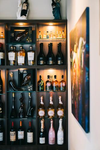 a shelf filled with lots of bottles of alcohol at O&O Hotel Oberursel Zentrum in Oberursel