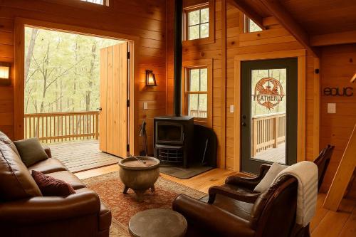 a living room with a couch and a tv in a cabin at Magical Family Tree House in Secluded Woodland near Germantown, Kentucky in Germantown
