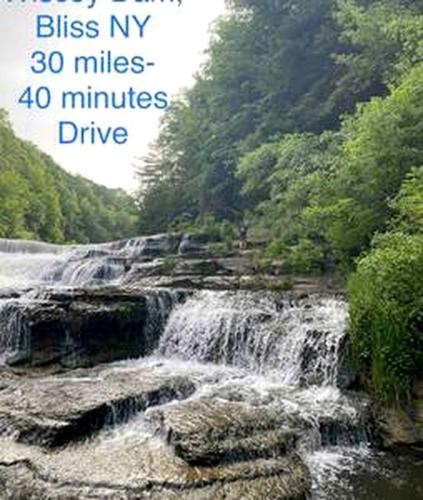 a picture of a waterfall with the words bless my miles minutes drive at Secluded Riverside Cabin for 8 in Belfast, NY with Rustic Amish-Built Retreat in Oramel