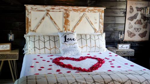 a bed with a heart made out of roses at Romantic Escapes in this Stunning A-Frame in North Carolina with Access to a Private Hot Tub and Fire Pit in Dobson