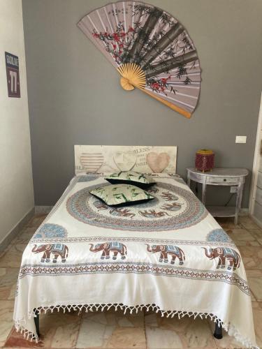 a bedroom with a bed with a blanket on it at finestra tra cielo e mare in Luni