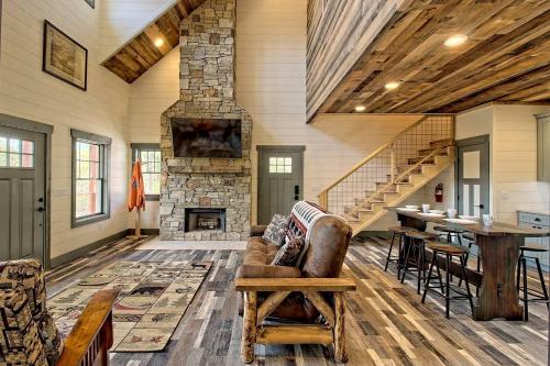 a living room with a couch and a stone fireplace at Stunning Cottage Rental Ideal for a Family to Go Glamping in Georgia in Shirley Grove