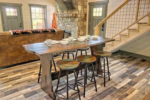 a wooden table and stools in a living room at Stunning Cottage Rental Ideal for a Family to Go Glamping in Georgia in Shirley Grove