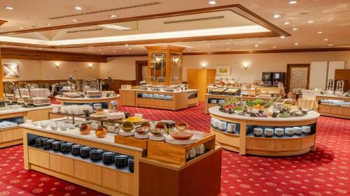 a restaurant with a buffet line with food on display at HOTEL MYSTAYS Sapporo Aspen in Sapporo