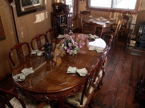a wooden table with flowers on top of it at Elegant Room for a Romantic Getaway near Warren, Pennsylvania in Russell