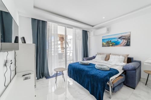 a bedroom with a bed with a blue blanket at Costa Dreams Costa Adeje in Costa de Adeje