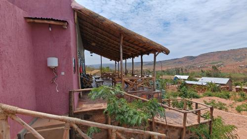 a purple building with a table and chairs at Akagera Park Inn in Akagera