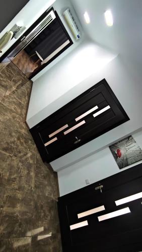 a kitchen with black cabinets and a ceiling at Chisinau Heart Central Apartment in Chişinău