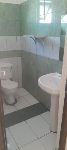 a bathroom with a toilet and a sink at Mawingo Appartments in Mombasa
