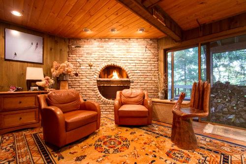 a living room with two chairs and a fireplace at Bed and Breakfast Ski Chalet with Yoga Studio in Stratton Mountain, Vermont in Stratton Mountain