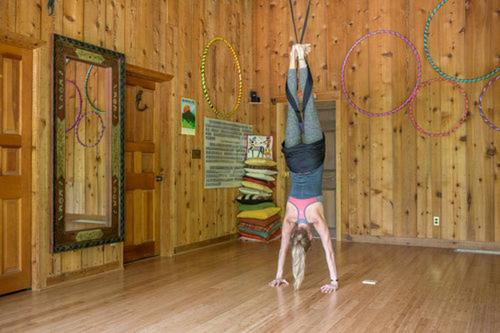 a woman doing a handstand in a gym at Bed and Breakfast Ski Chalet with Yoga Studio in Stratton Mountain, Vermont in Stratton Mountain