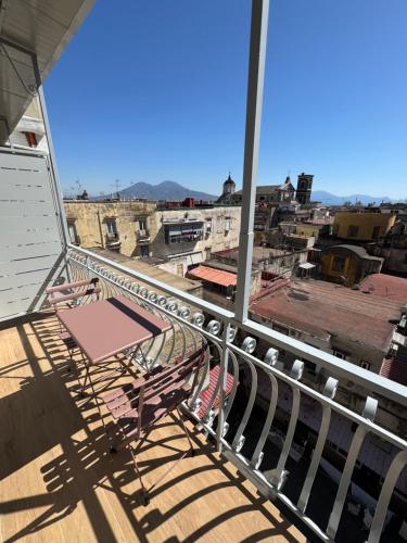 a balcony with a table and a view of a city at WANDERLUST SPACCANAPOLI Points Of View in Naples