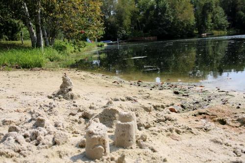 a sand castle on a beach next to a river at Rustic Family Cabin Rental with a Fire Pit near Wisconsin Dells in Tomah