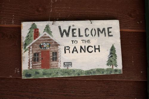 a welcome to the ranch sign on a wooden wall at Rustic Family Cabin Rental with a Fire Pit near Wisconsin Dells in Tomah
