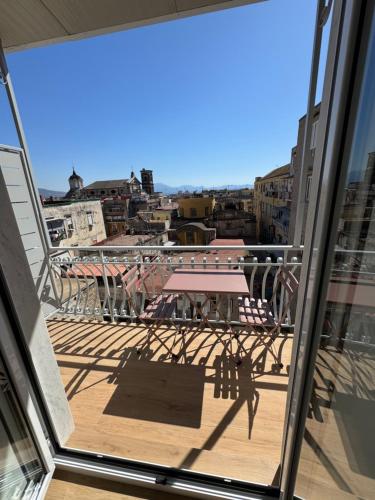 a balcony with a table and a view of a city at WANDERLUST SPACCANAPOLI Points Of View in Naples