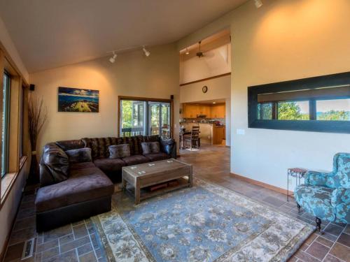 a living room with a leather couch and a table at Tree-House Style Cabin for Rent near Boone, North Carolina in Beech Mountain