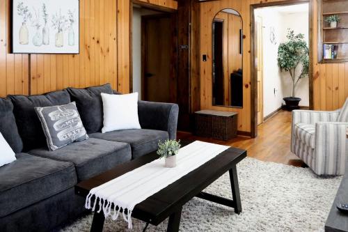 a living room with a couch and a coffee table at Cozy Mountain Cabin with Hot Tub & Scenic Views in Stanley, Virginia in Marksville