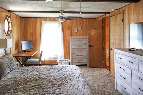 a bedroom with a bed and a dresser and a desk at Cozy Mountain Cabin with Hot Tub & Scenic Views in Stanley, Virginia in Marksville