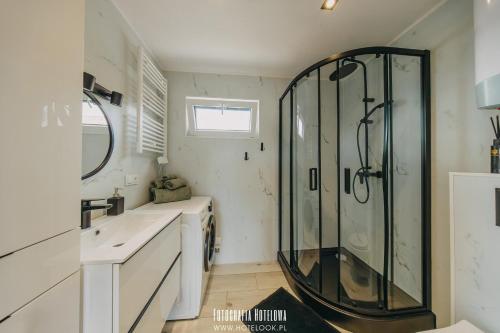 a bathroom with a shower and a sink at Chillzone u Grochów in Bieniowice