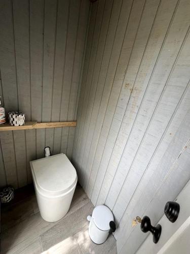 a small bathroom with a toilet and a tub at Eco-Friendly, Abstract Treehouse Surrounded by Wildlife and Hiking Trails For a Special Getaway in Sparrow Bush, New York in Cahoonzie