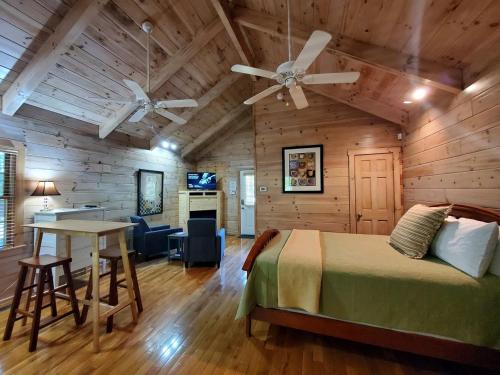 a bedroom with a bed and a table in a room at Tranquil Riverside Cabin Haven Near New River, Virginia in Galax