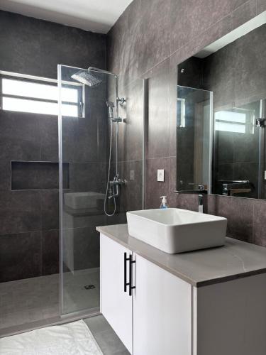 a bathroom with a sink and a shower at The Royal Vista by SOV in Grand-Baie