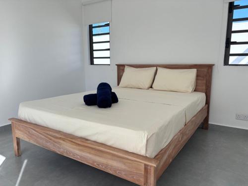 a bed with a blue stuffed animal sitting on it at The Royal Vista by SOV in Grand-Baie
