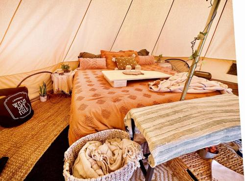 a room with a tent with a bed and a table at The Pink Pony Yurt, New Cuyama, CA in New Cuyama
