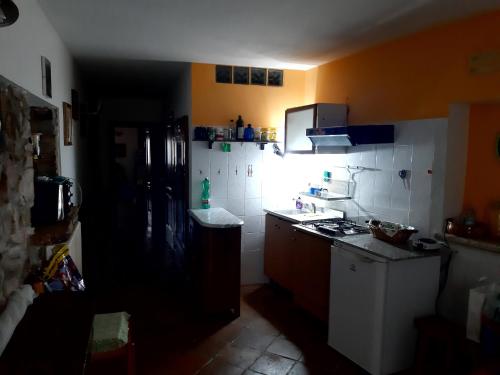 a kitchen with a refrigerator and a stove top oven at Parva Domus in Campolattaro