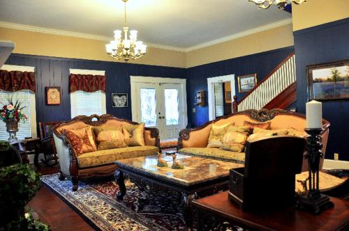 a living room with two couches and a coffee table at Luxurious Bed and Breakfast Vacation Rental for Large Groups in East Texas in Zavalla