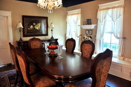 a dining room with a wooden table and chairs at Luxurious Bed and Breakfast Vacation Rental for Large Groups in East Texas in Zavalla
