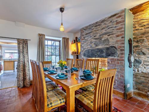 a dining room with a wooden table and chairs at 4 Bed in Bala 94665 in Bala
