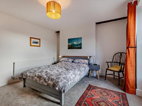 a bedroom with a bed and a chair at 4 Bed in Bala 94665 in Bala