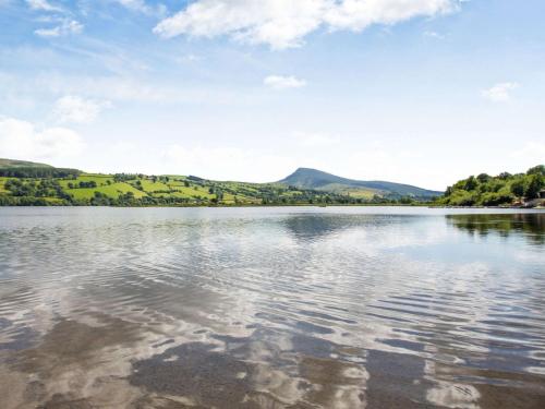a view of a lake with mountains in the background at 4 Bed in Bala 94665 in Bala