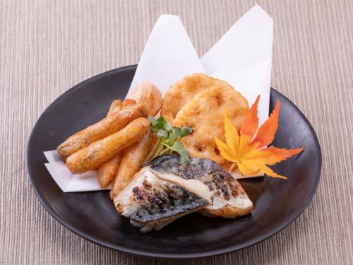 a plate of food with fish and french fries at Hotel Intergate Tokyo Kyobashi in Tokyo