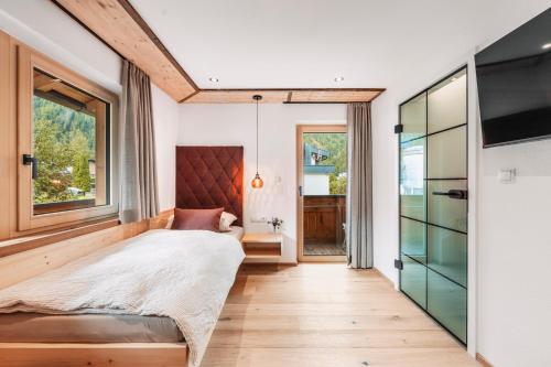 a bedroom with a bed and a large window at Chalet-Midl in Umhausen