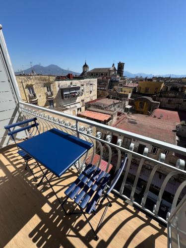 a balcony with chairs and a view of a city at WANDERLUST SPACCANAPOLI Points Of View in Naples
