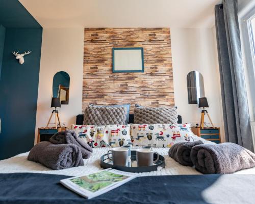 a bedroom with a bed and a brick wall at Comme une Envie d'air FORET in Guémy