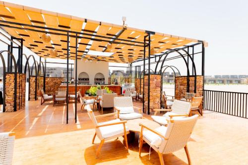 a patio with chairs and tables on a roof at Sentido Naga Bay - Adults friendly in Hurghada
