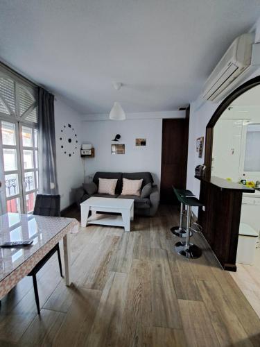 a living room with a couch and a table at Vivienda Rural Sentirte 1 Centro de Aracena in Aracena