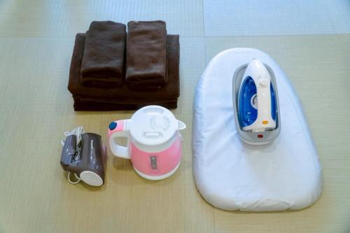 a nintendo wii remote control and other items on a table at Tokyo Tower Cozy Stay 201 Tamachi & Mita Access in Wada