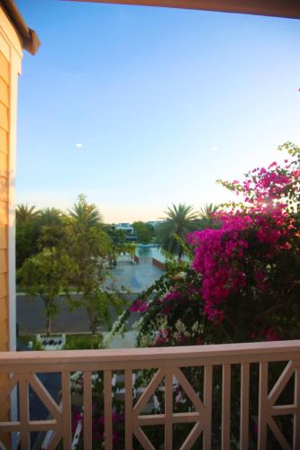 a view from the balcony of a resort with flowers at Modern 3BR Villa , Poolside, 4min Shuttle to Beach in Bình Tú