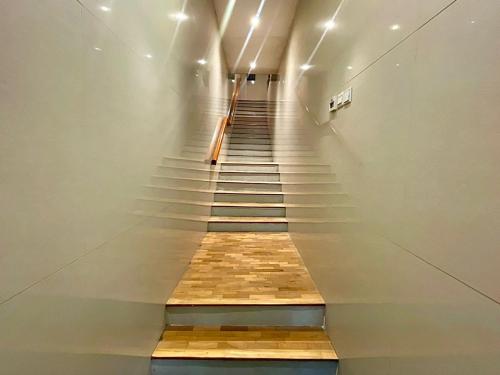 a staircase in a building with a wooden floor at Heritage Collection on Boon Tat in Singapore